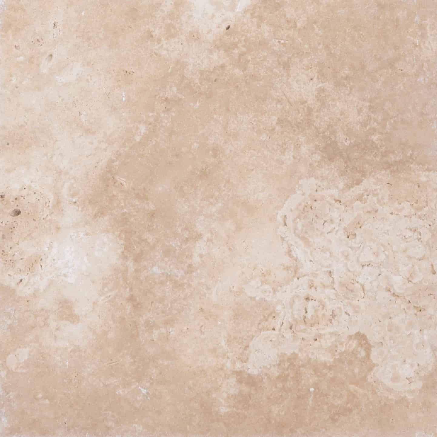 Close-up of Stonelux's Ivory Travertine natural stone, showcasing its creamy beige color and subtle veining. The surface features a smooth, slightly porous texture ideal for elegant hardscaping and pool projects.