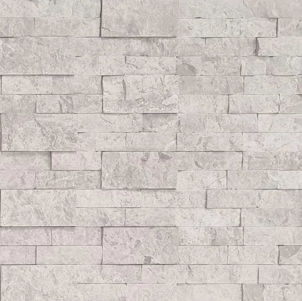 Close-up of the Pera Cream Marble Splitface Ledger Panel (6x24) showcasing its natural stone texture and creamy beige tones. The marble's splitface finish highlights subtle veining and varied surface characteristics, ideal for elegant wall installations.