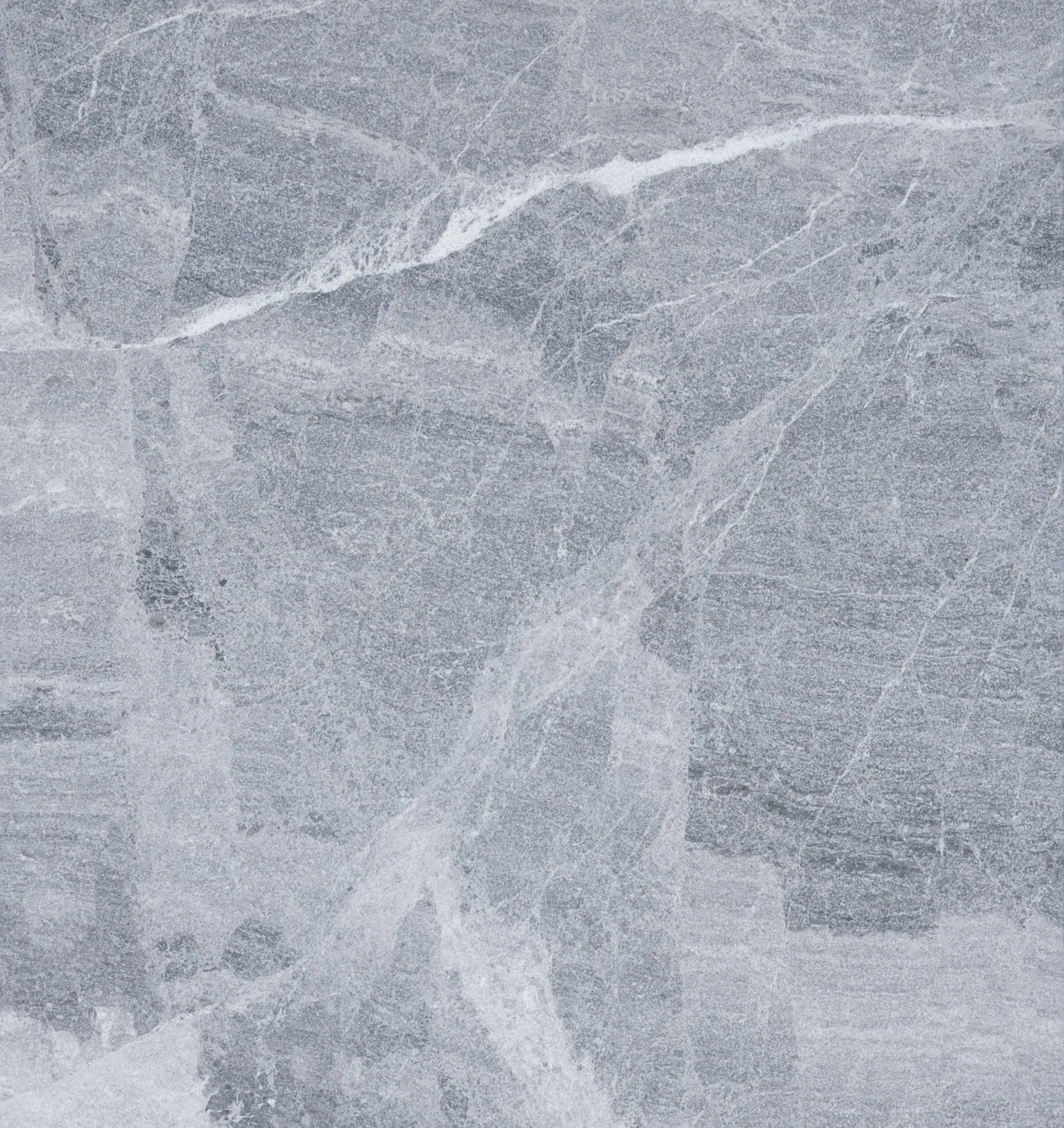 Gray stone surface with subtle white veining and textured patterns throughout, resembling natural marble or granite, similar to the elegant look of Aegean Grey Marble.