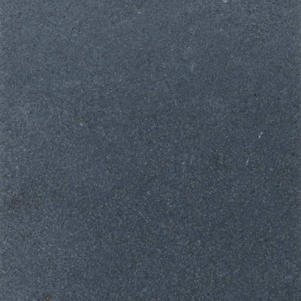 Close-up view of a dark gray, textured stone surface of Black Basalt, with a slightly rough and matte appearance. Subtle variations in color and small specks are scattered throughout.