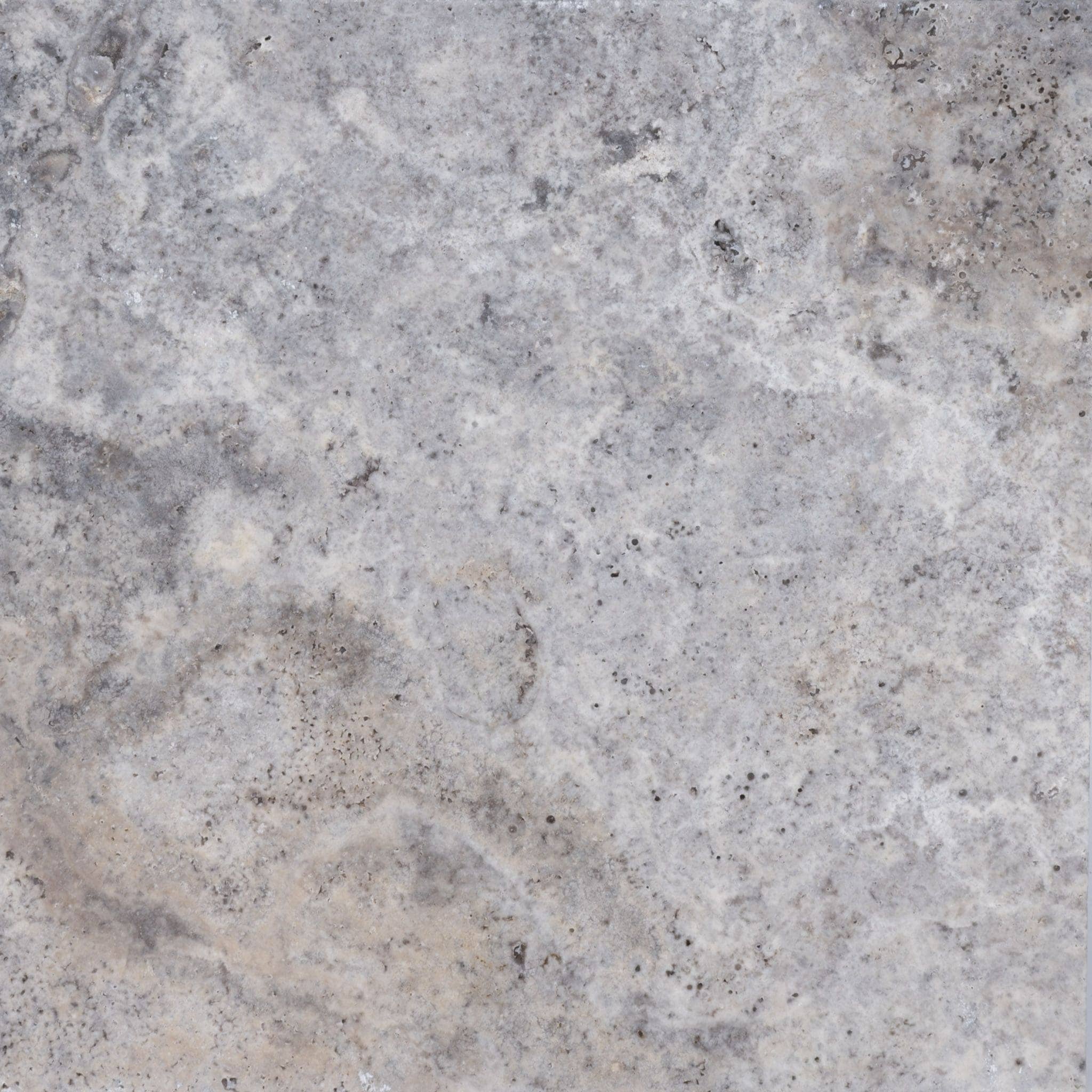 A close-up of a textured, gray stone surface with subtle variations in color, including light and dark gray areas, mottled patterns, and small specks throughout.