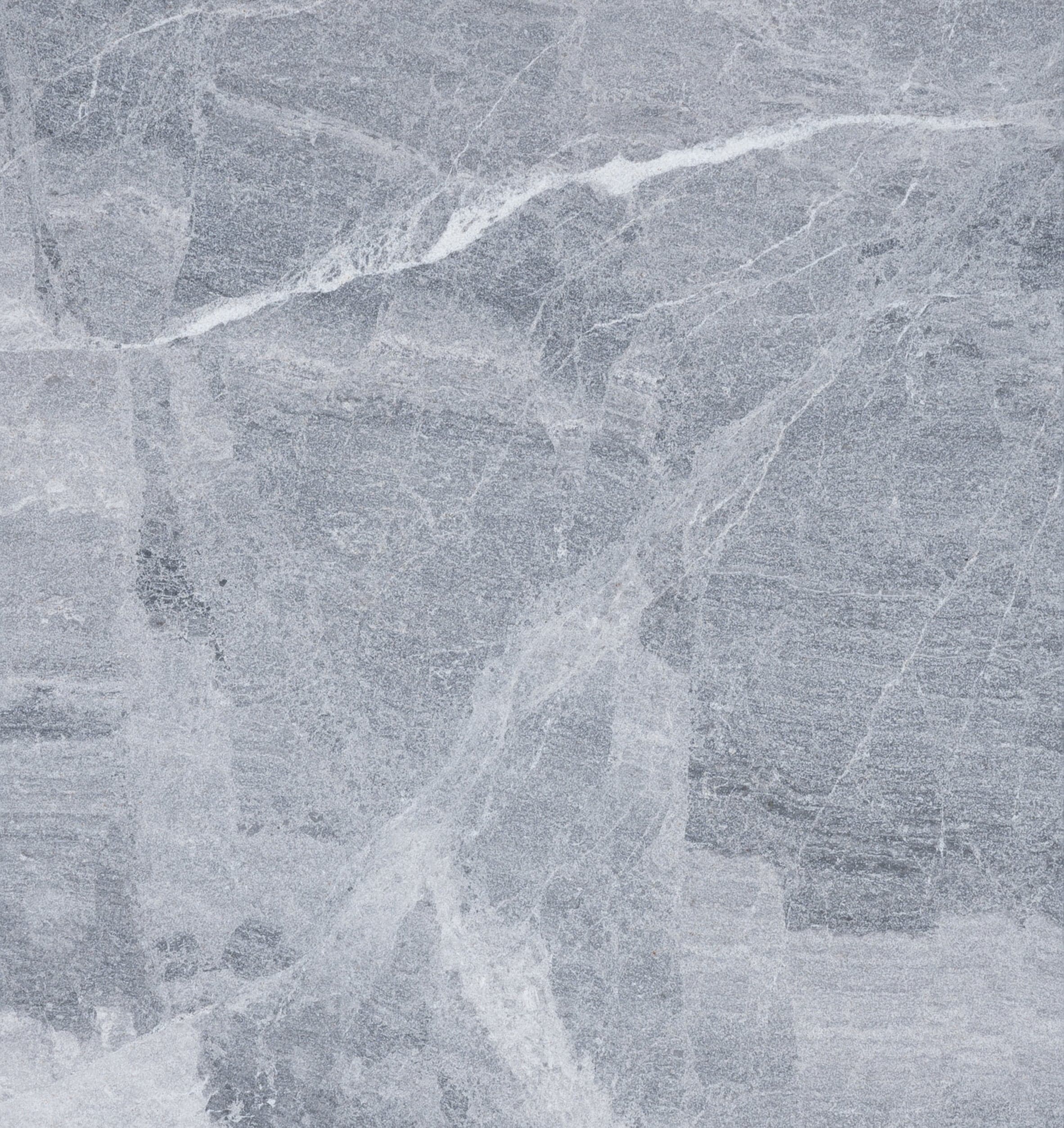 Gray stone surface with subtle white veining and textured patterns throughout, resembling natural marble or granite, similar to the elegant look of Aegean Grey Marble.