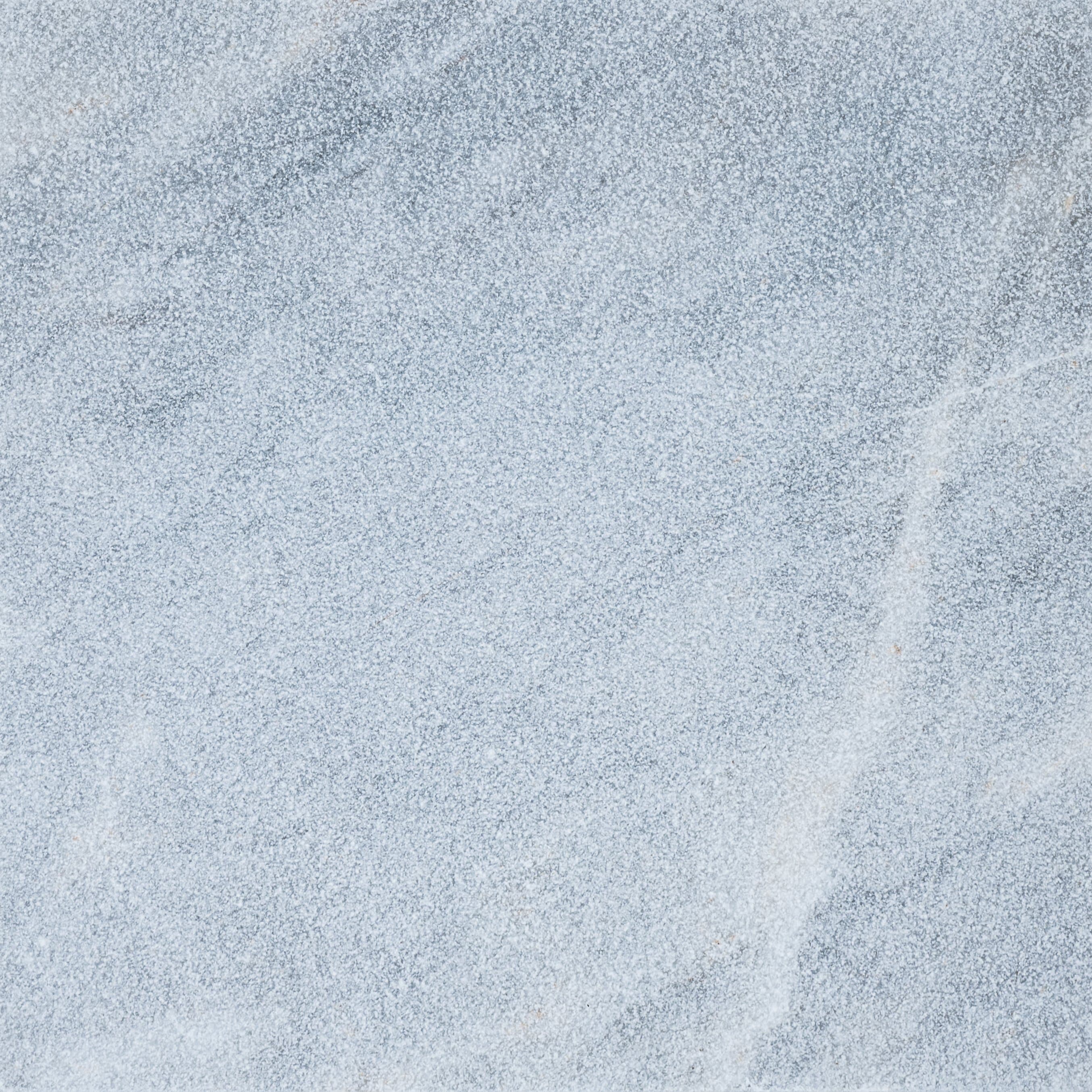 Close-up of Arctic Grey Marble from STONELUX, showcasing its smooth texture and subtle grey veining. The natural stone exhibits a soft, elegant appearance ideal for luxury hardscape projects and high-end installations.