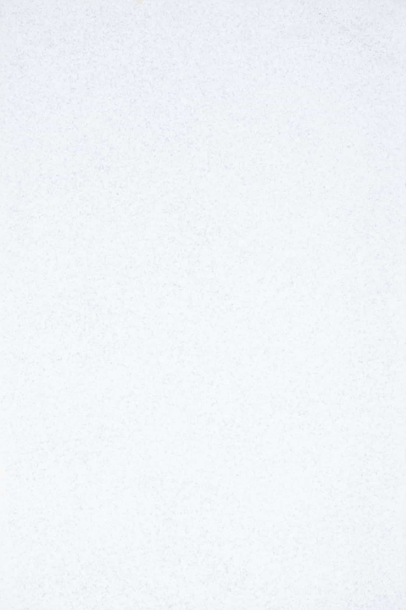 Close-up of Afyon White Marble Sand Blasted 16x24 3cm Paver by STONELUX. The marble showcases a smooth, sandblasted texture with subtle, elegant veining in a pristine white hue, ideal for luxury hardscape projects and pool surrounds.