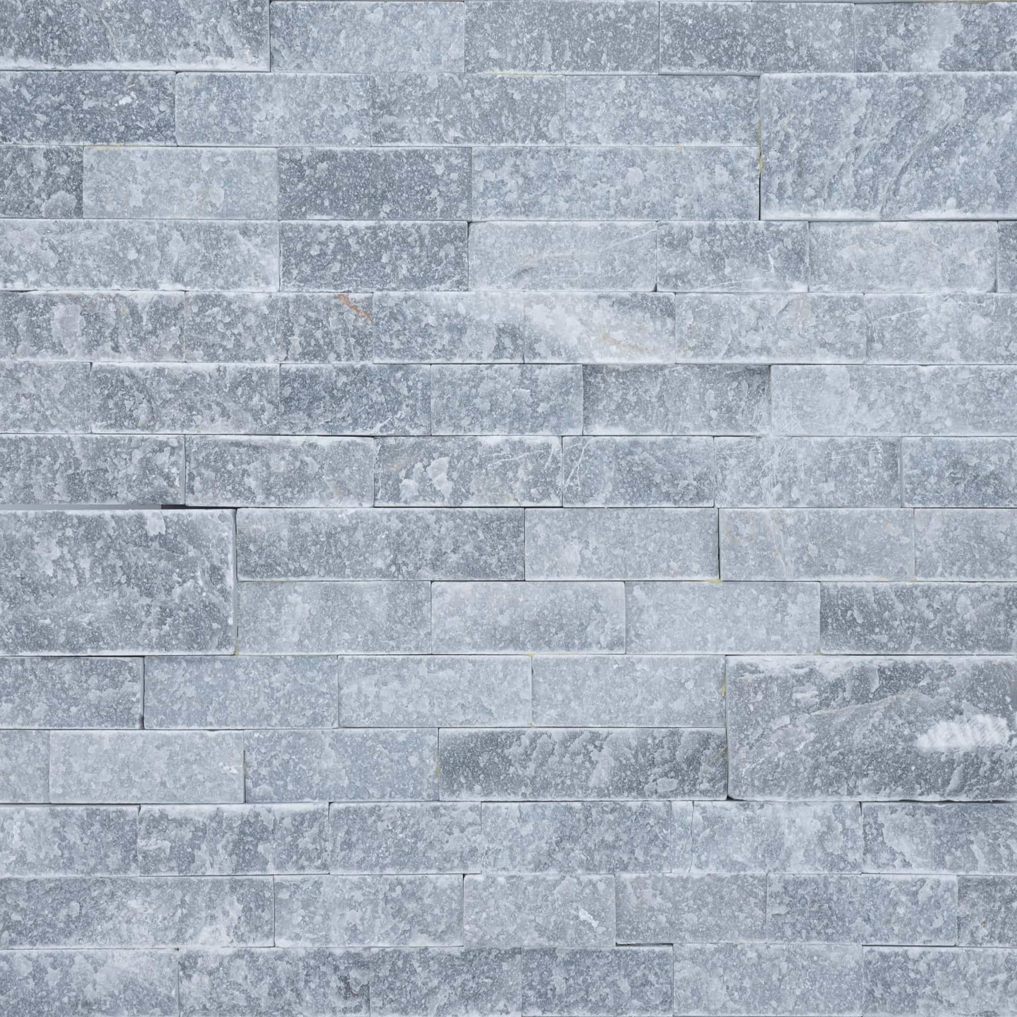 Close-up image of Afyon Grey Marble Splitface Ledger Panel in 6x24 size. The textured marble shows cool grey movement for wall veneer, outdoor living walls, pool features, and architectural cladding.