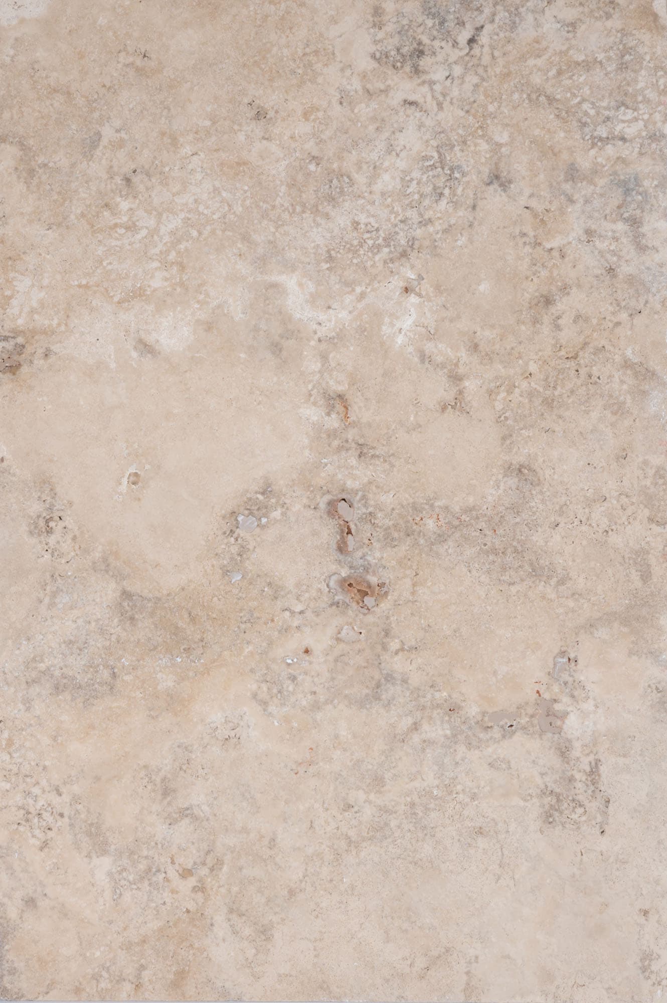 Close-up of Philly Travertine Tumbled 16x24 3cm Paver by STONELUX, showcasing its natural stone texture with beige and cream tones, subtle veining, and a tumbled finish, ideal for high-end hardscape projects and pool decks.