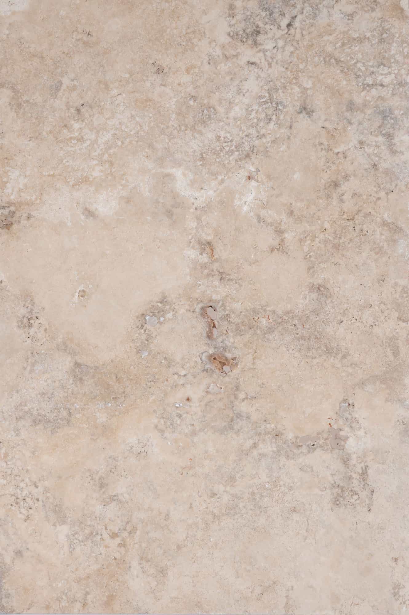 Close-up of Philly Travertine Tumbled 16x24 3cm Paver by STONELUX, showcasing its natural stone texture with beige and cream tones, subtle veining, and a tumbled finish, ideal for high-end hardscape projects and pool decks.