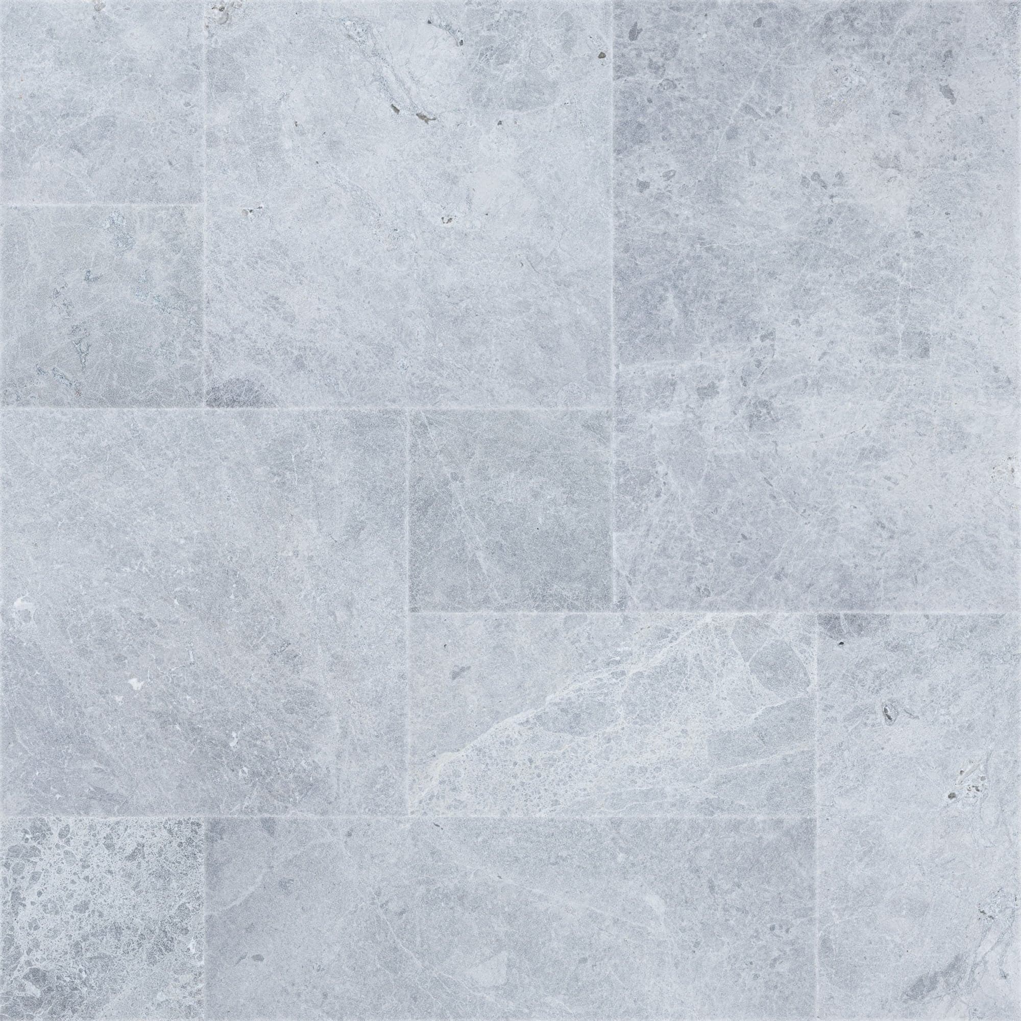 Close-up of Tundra Grey Marble Sand Blasted French Pattern 3cm Paver, showcasing a natural stone surface with subtle grey veining and a textured sandblasted finish. Ideal for elegant hardscape projects and pool decks, highlighting its premium marble qu...