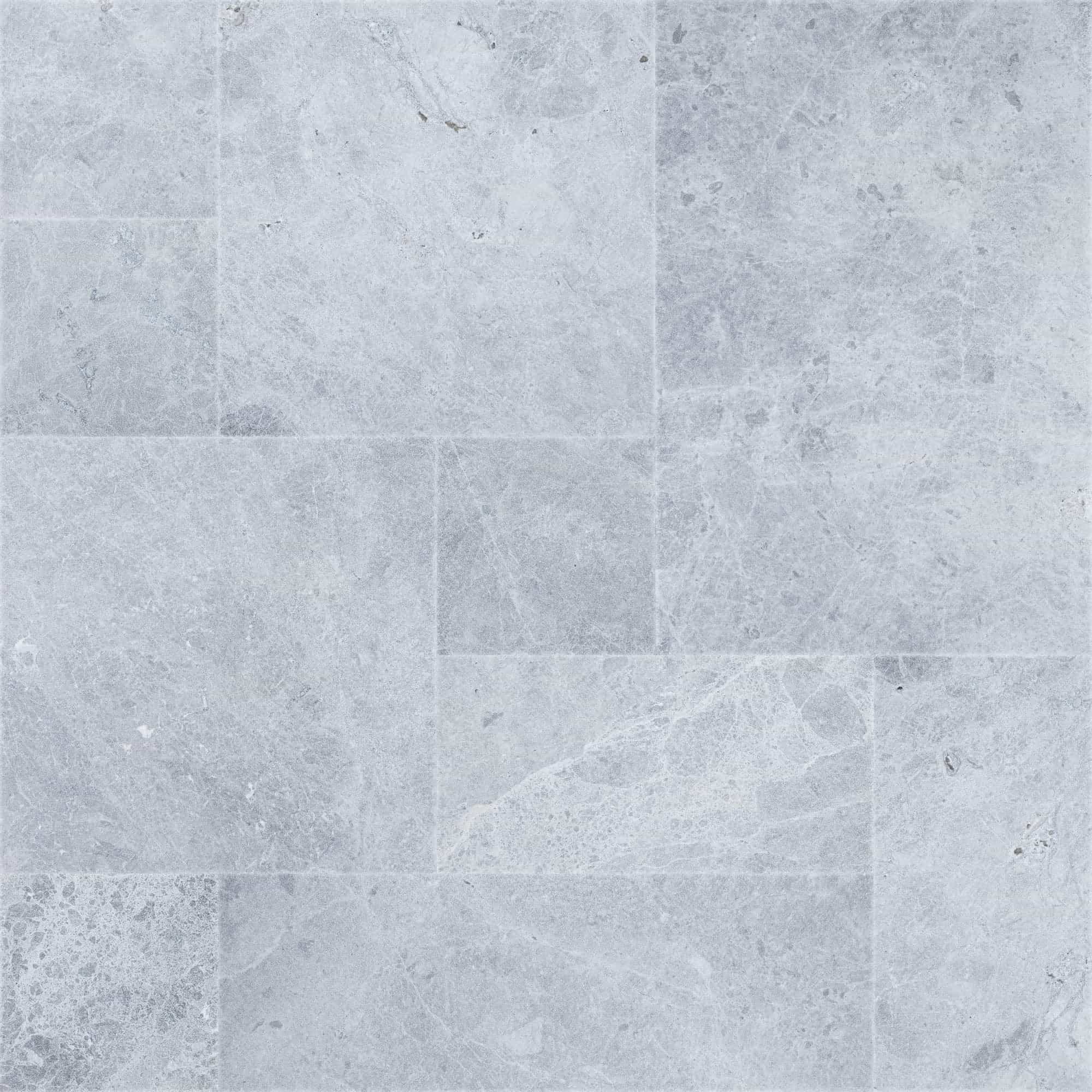 Close-up of Tundra Grey Marble Sand Blasted French Pattern 3cm Paver, showcasing a natural stone surface with subtle grey veining and a textured sandblasted finish. Ideal for elegant hardscape projects and pool decks, highlighting its premium marble qu...