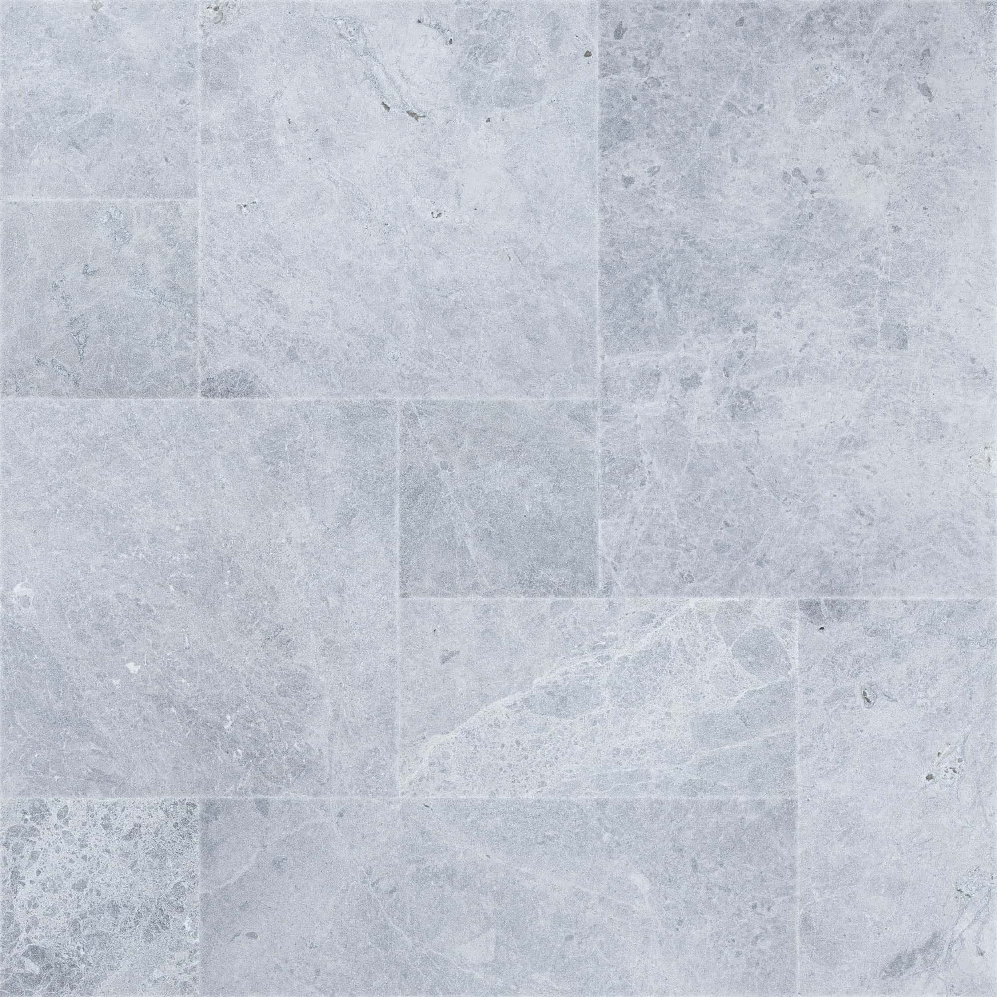 Close-up of Tundra Grey Marble Sand Blasted French Pattern 3cm Paver, showcasing a natural stone surface with subtle grey veining and a textured sandblasted finish. Ideal for elegant hardscape projects and pool decks, highlighting its premium marble qu...