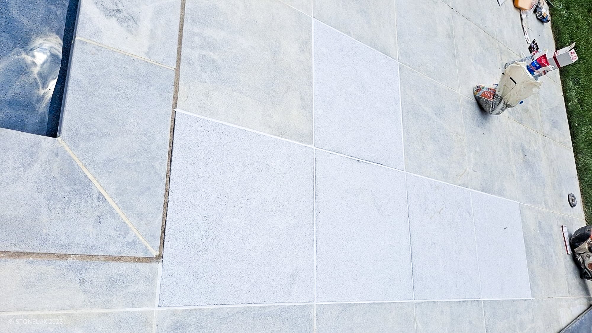 Mismatched marble pavers installed as replacement on existing deck. Mismatched marble pavers.