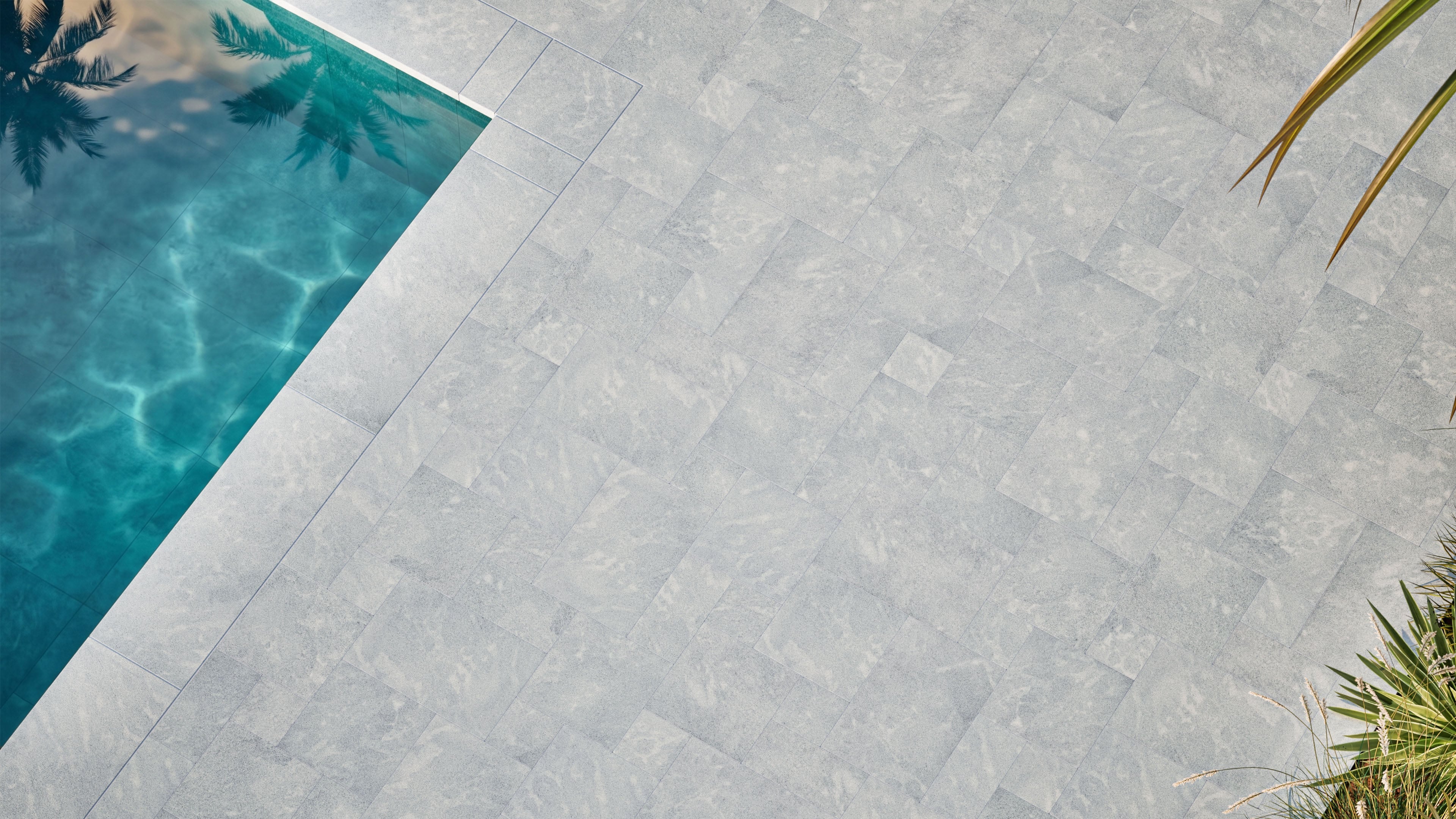 Design visualization of Afyon Grey Marble French Pattern pavers in a contemporary pool and outdoor living setting, showing the collection's light cool-grey tone and soft blue-grey movement.