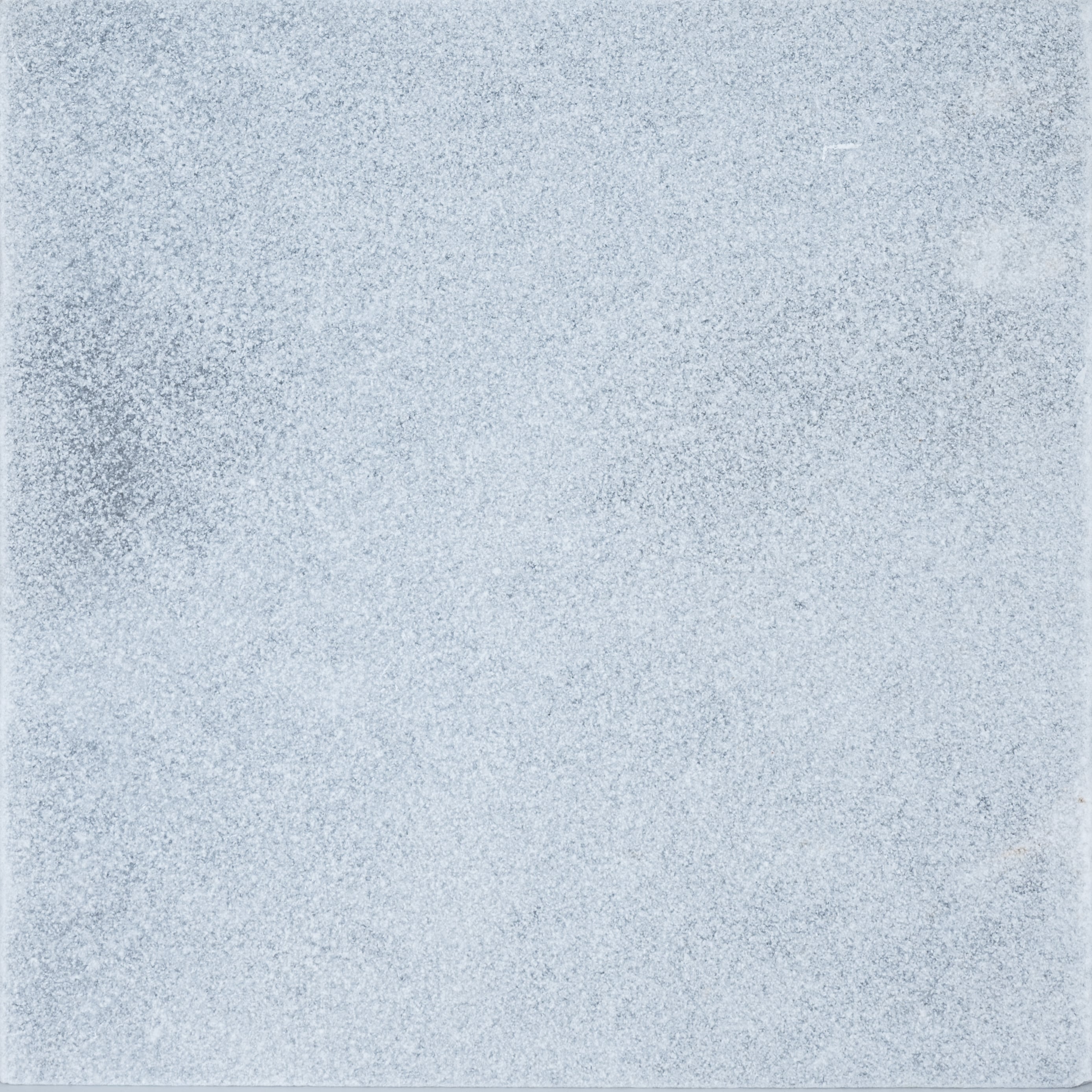 Close-up of Arctic Grey Marble from STONELUX, showcasing its natural stone texture with subtle grey veining and a smooth, polished surface. Ideal for luxurious hardscape projects, pool builds, and renovations. Perfect for modern or traditional designs.