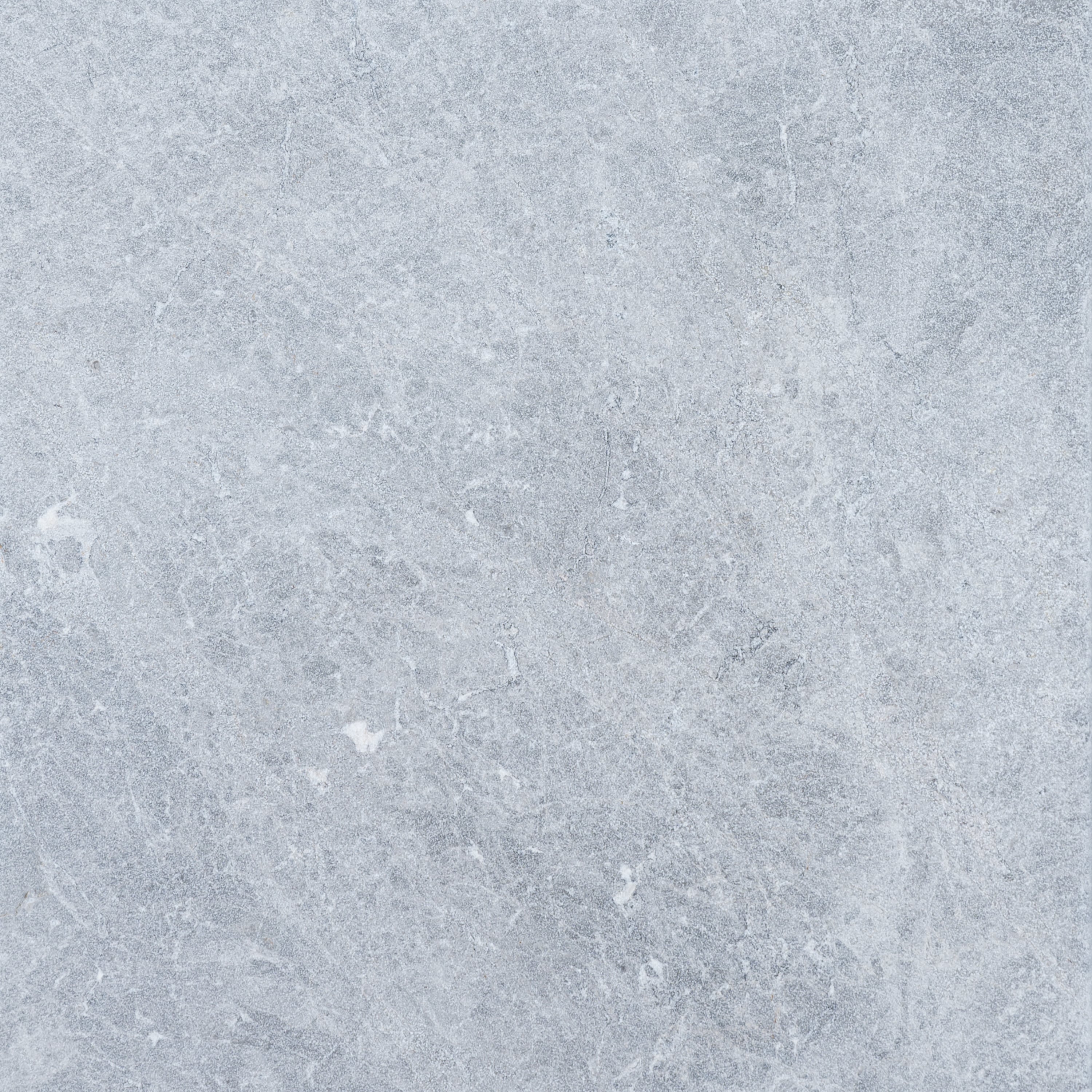 Close-up of Tundra Grey Marble from STONELUX, showcasing its natural stone texture with subtle grey veining and a smooth, matte finish. Ideal for premium hardscape projects and elegant pool builds, offering a sophisticated and modern aesthetic.