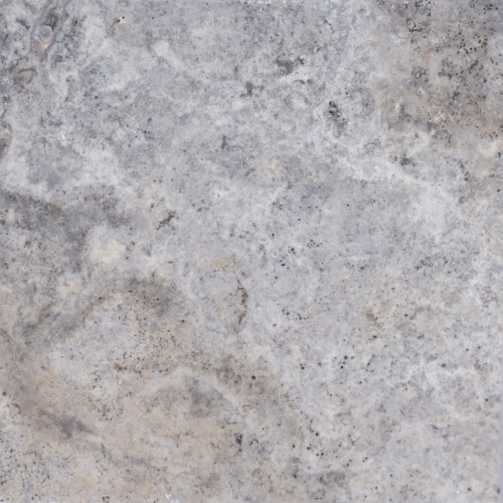 A close-up of a textured, gray stone surface with subtle variations in color, including light and dark gray areas, mottled patterns, and small specks throughout.