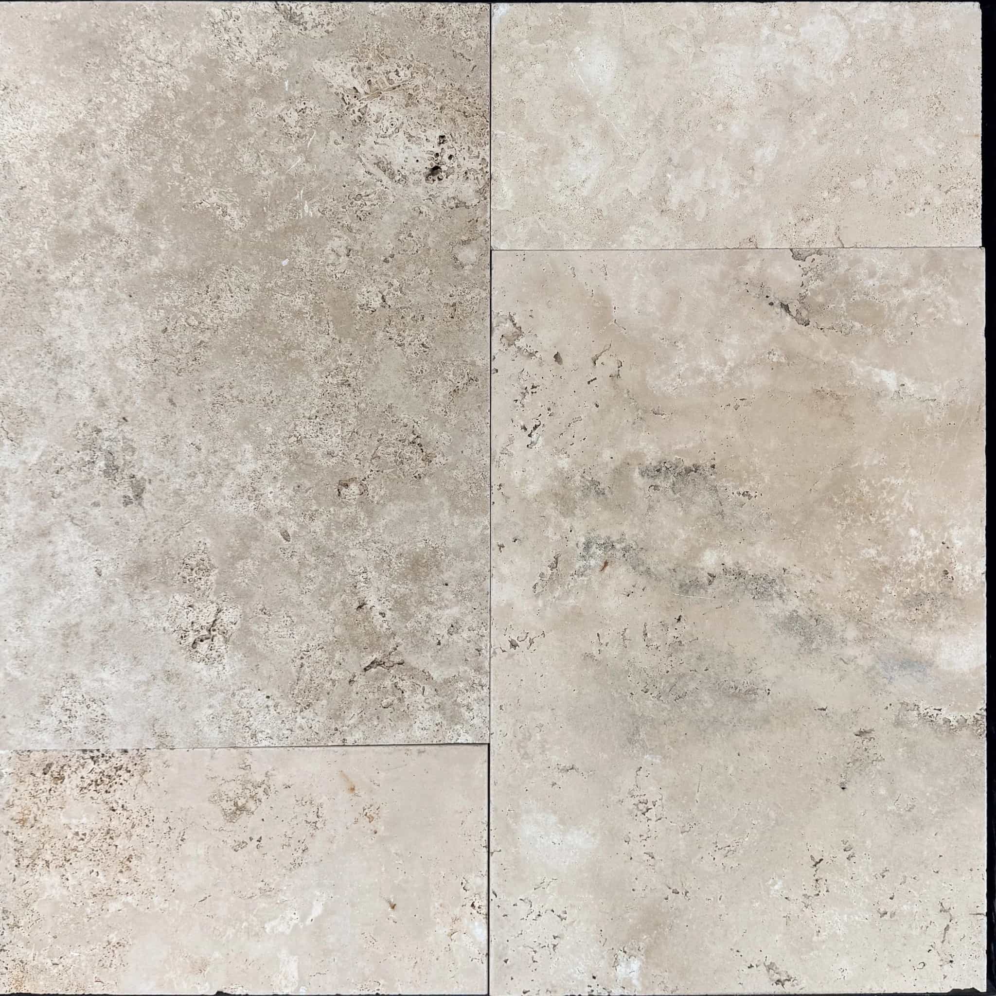 Close-up of Ivory Travertine Tumbled French Pattern 3cm Paver by STONELUX, showcasing its natural stone texture. The paver features a soft beige tone with subtle veining and a tumbled finish, perfect for elegant pool decks and patios.