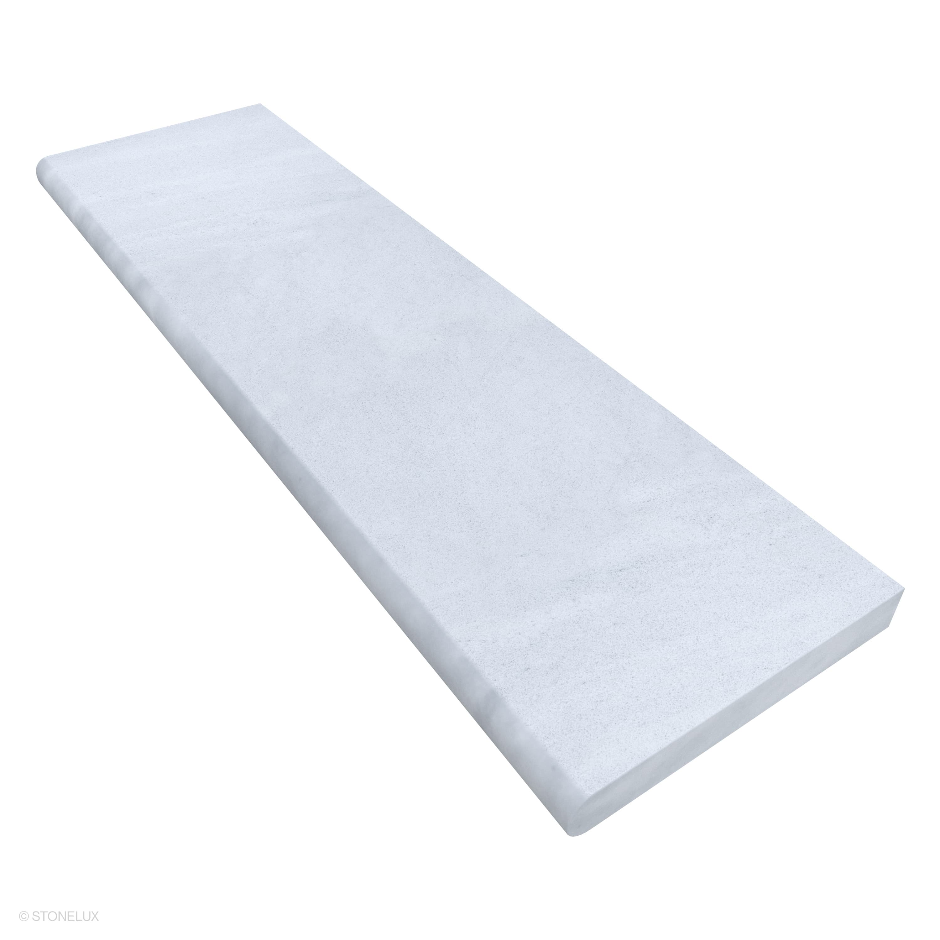 Close-up of Afyon White Marble Sand Blasted 14x48x2 Single Bullnose Coping by STONELUX. The marble exhibits a smooth sandblasted texture with subtle white veining, perfect for elegant pool edges or wall caps, enhancing luxury hardscape projects.