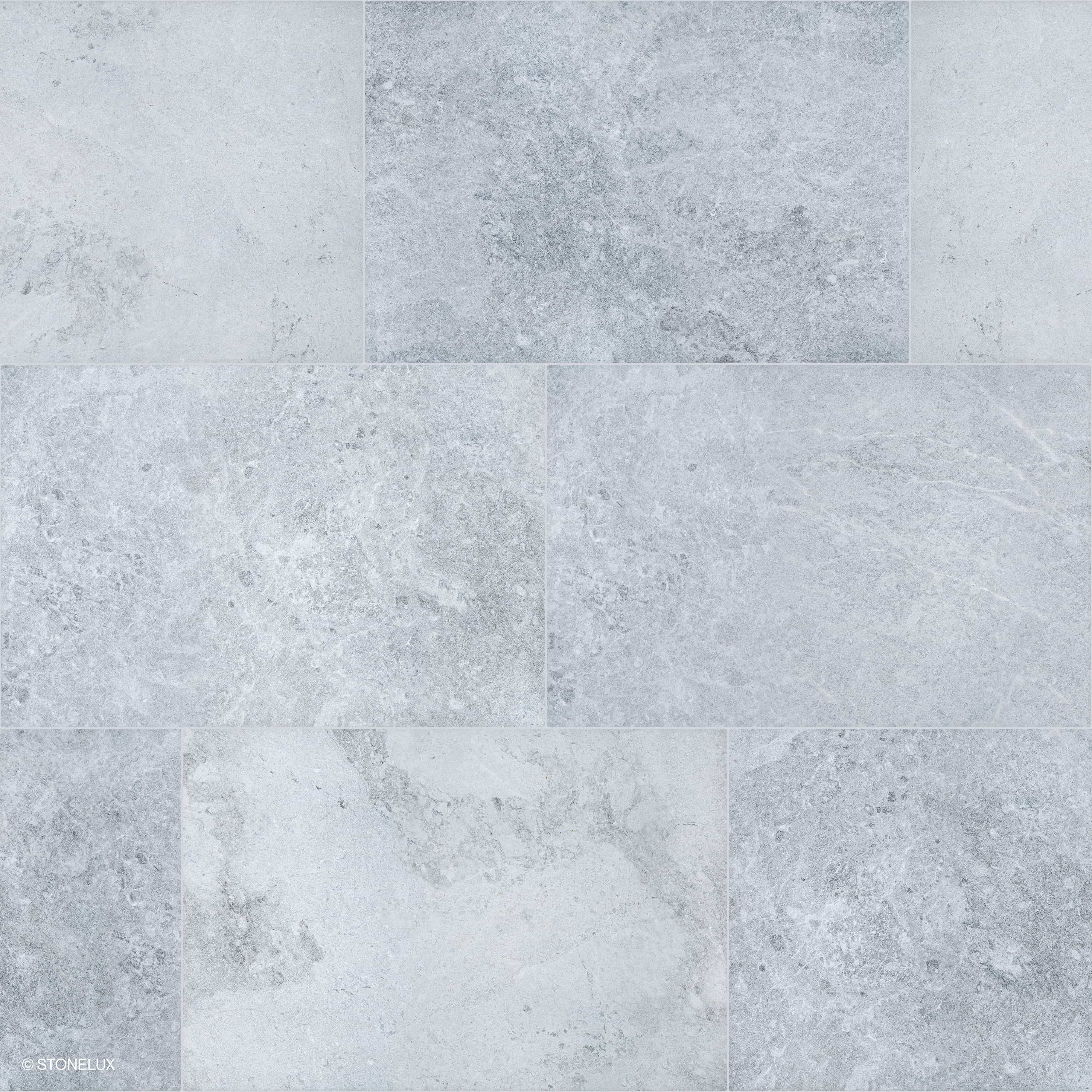 Close-up of Tundra Grey Marble Sand Blasted 16x24 3cm Paver by STONELUX. Features a subtle grey palette with intricate veining and a sandblasted finish, ideal for modern hardscape projects. Durable marble surface, perfect for patios and pool decks.