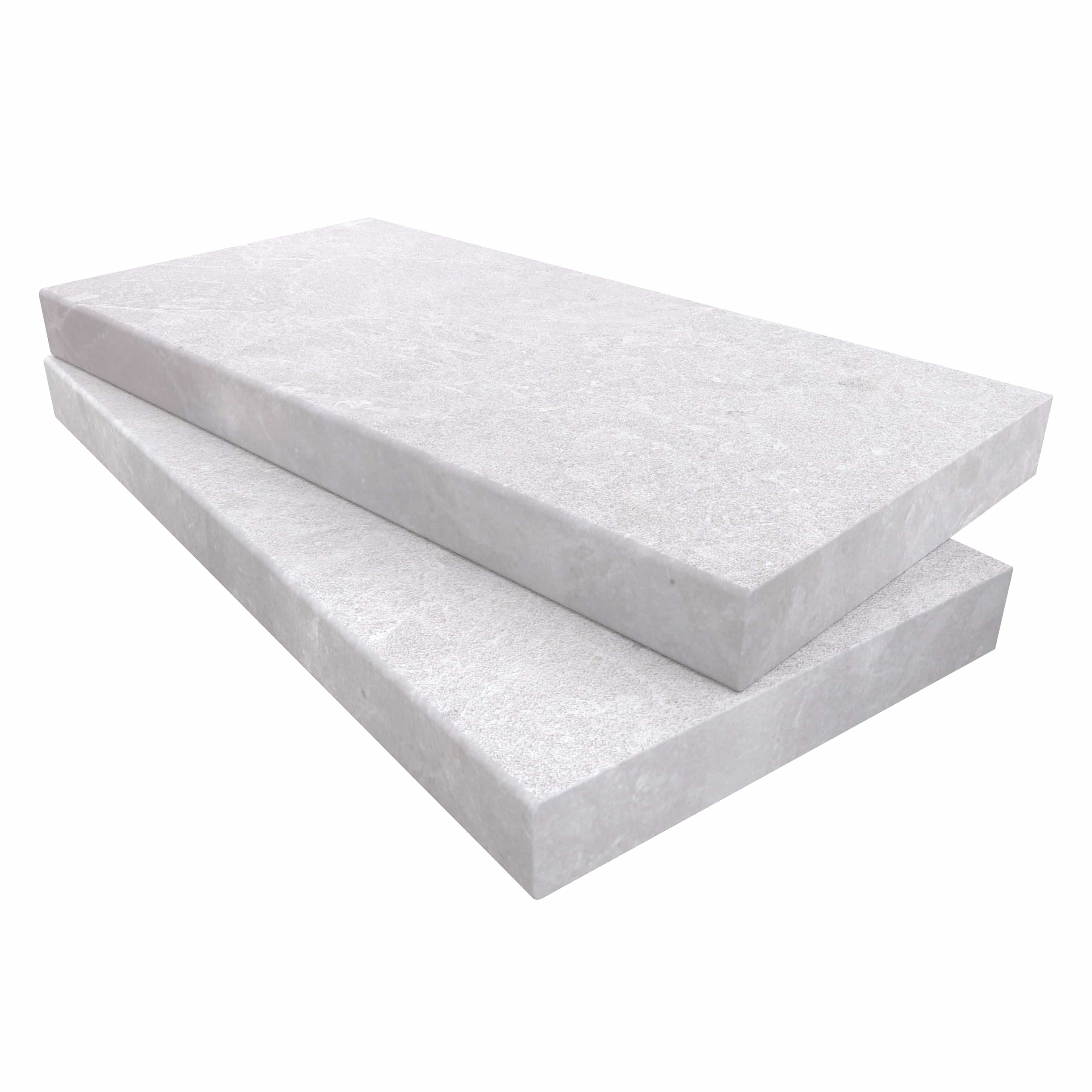 Close-up of Pera Cream Marble Sand Blasted 12x24x2 Eased Edge Coping. The marble features a light cream hue with a textured sandblasted finish, highlighting subtle veining. Ideal for pool edges and steps. High-quality, durable material from STONELUX.