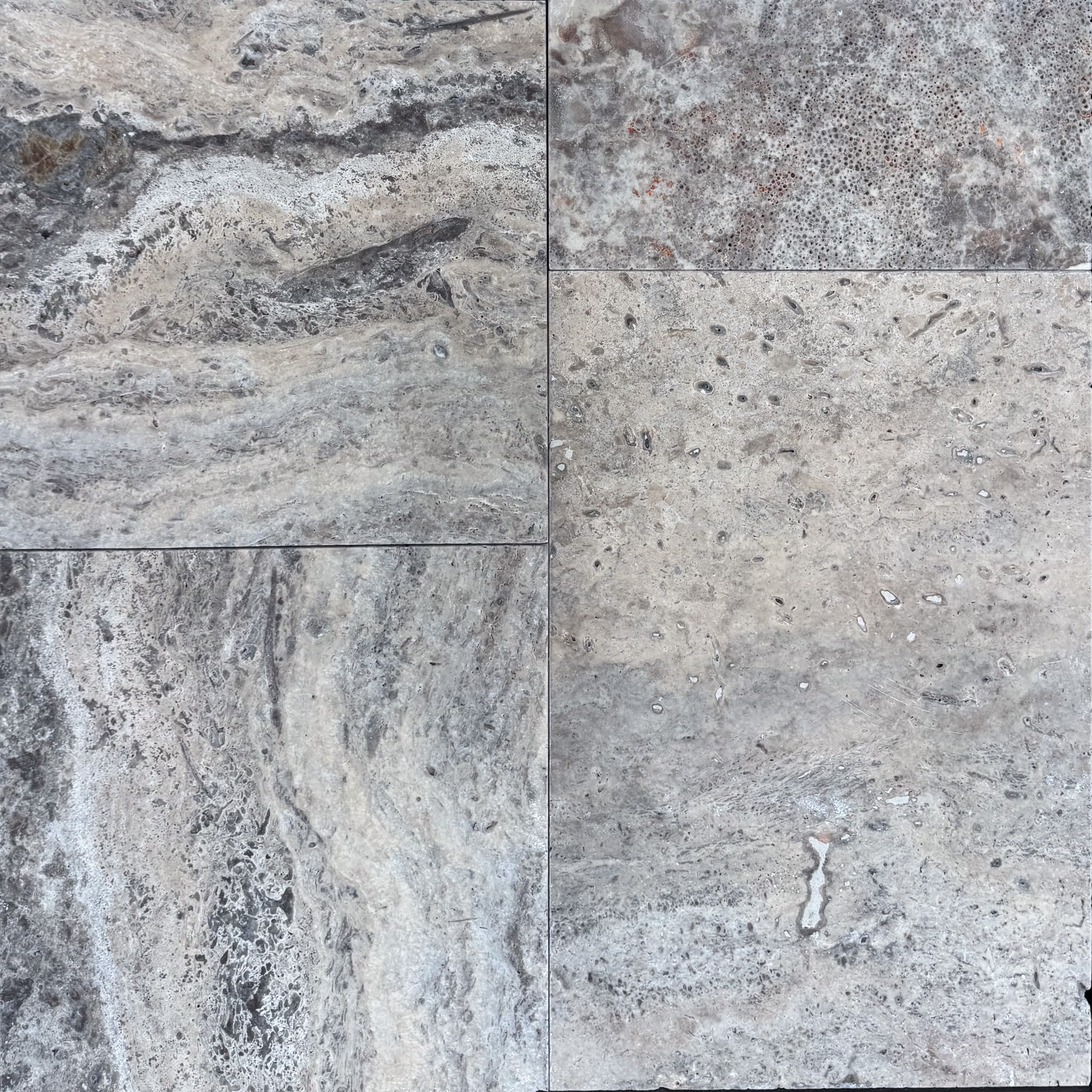 Close-up of Silver Travertine Tumbled French Pattern 3cm Paver - Select by STONELUX. Showcases natural stone texture with intricate veining and a soft, tumbled finish. Ideal for hardscape projects, offering a blend of gray and beige tones for elegant d...