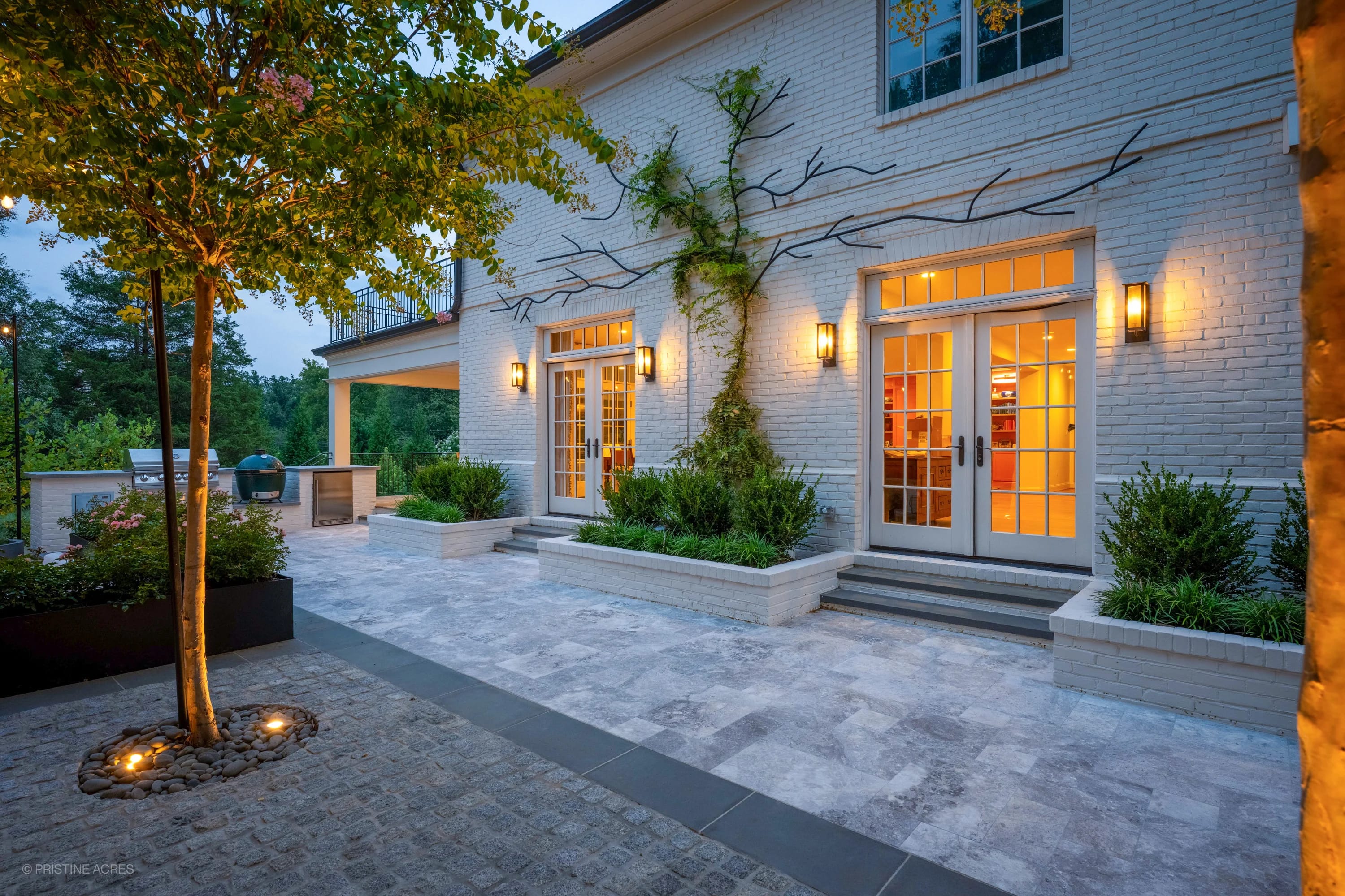 Tundra Grey Marble pool deck in McLean, VA features elegant bluestone coping. Modern design with lush landscaping, soft lighting, and a cozy outdoor setup. Ideal for luxury hardscape and poolside relaxation, enhancing the contemporary ambiance.
