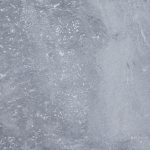 Textured Aegean Grey marble surface with natural patterns and white flecked details.