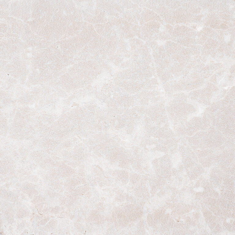 A close-up image from the Pera Cream Marble, featuring a textured beige surface with subtle veins and natural variations in pattern and color.