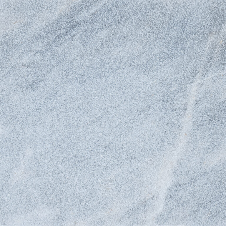 Close-up textured image of a blue Arctic Grey Marble surface with subtle white lines running across it, resembling fine sand or a rough mineral texture.
