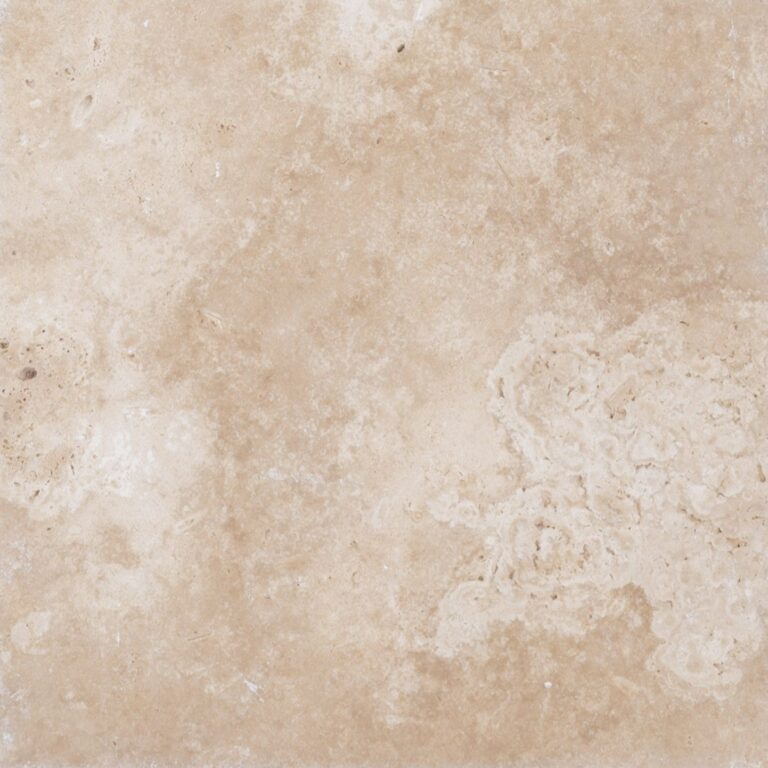 Close-up photograph of an ivory travertine surface from the Travertine Collection with subtle dark spots and intricate white vein patterns.