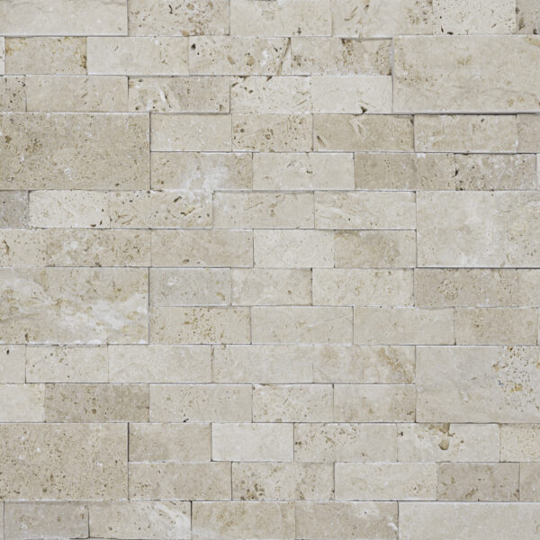 A detailed texture of an Ivory Travertine Splitface Ledger Panel - 6"x24" wall, showcasing an array of stones in varying sizes, neatly configured in a horizontal splitface ledger panel pattern.