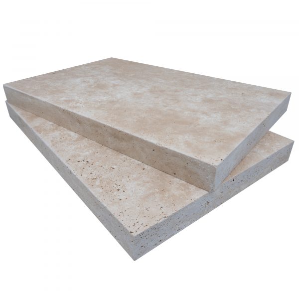 Two large, stacked Premium Ivory Travertine Tumbled 16"x24"x2" Eased Edge Copings on a plain white background, showcasing details of their textured surfaces and eased edges.