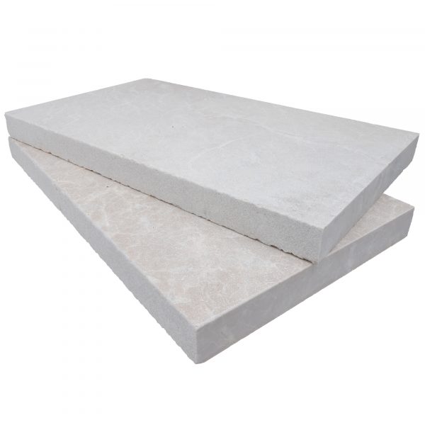 Two large, rectangular Pera Cream Marble Sand Blasted 14"x24"x2" Eased Edge Copings stacked on top of each other, isolated against a white background.