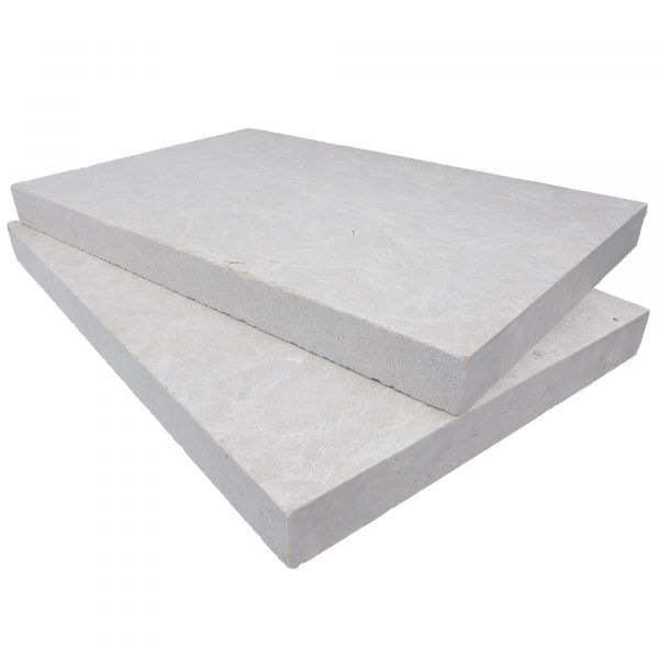 Two large, stacked Pera Cream Marble Sand Blasted 16"x24"x2" Eased Edge Copings on a plain white background, showcasing their textured surfaces and clean-cut edges.