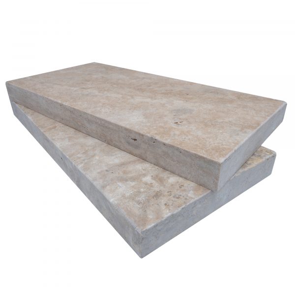 Two stacked Philly Travertine Tumbled 12"x24"x2" rectangular copings on a plain white background. The copings featuring an eased edge coping, rests slightly offset, revealing the textured surfaces of both.