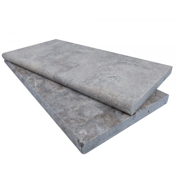 Two large Silver Travertine Tumbled 12"x24"x3CM Single Bullnose Copings stacked on top of each other against a plain white background. The copings are rectangular and have a smooth, tumbled surface.