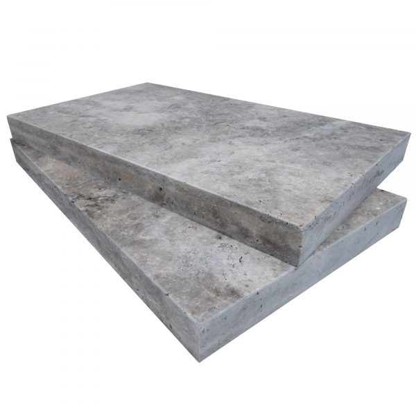 Two stacked Silver Travertine Tumbled 14"x24"x2" copings with eased edge coping on a plain background, showcasing visible textures and edges.