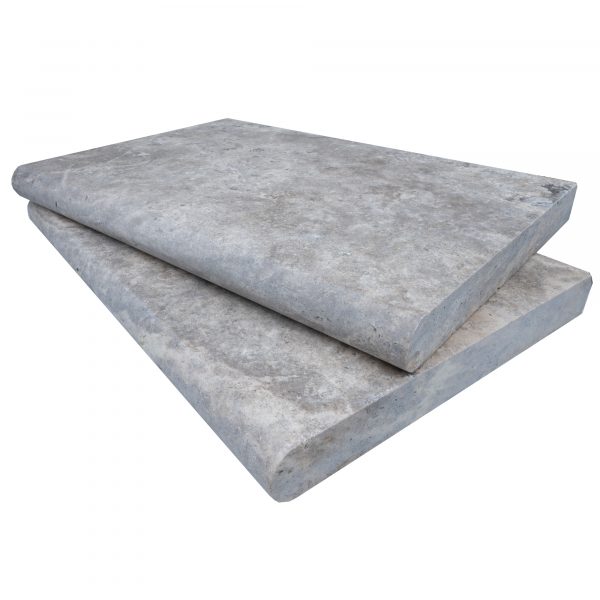 Two large Silver Travertine Tumbled 16"x24"x2" Single Bullnose Copings stacked on top of each other, isolated on a white background.