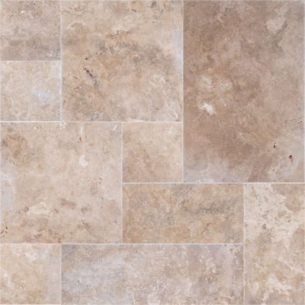 A Walnut Travertine Tumbled French Pattern Paver laid out in varying sizes, creating a seamless, textured surface. Each tile features natural stone markings and subtle color variations.